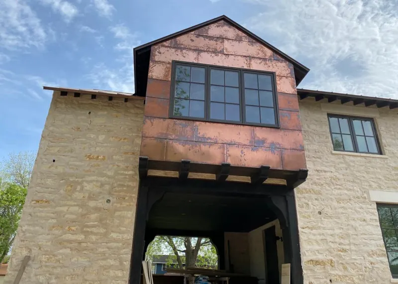 Copper metal panel facade on a stone building for Metal Roof Coating in St. Simons